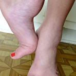 Second pic of Barefoot brunette Bambi Blu with big melons and hairy snatch strips naked