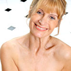 Fourth pic of [All Over 30] Blonde mom removes her red dress and underwear before posing naked - IWantMature.com