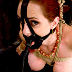 Fourth pic of Bosomy redhead slave Mz Berlin getting rope tied, raised off the ground and tortured