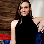 Second pic of Free Mirabella shows off her petite body and delectable pussy as she strips on the chair.