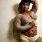Second pic of Playful bodybuilder Taz in see through fishnet top demonstrates her tits