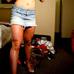 Third pic of Muscle blonde April Michelle in denim mini skirt takes off her t-shirt and bra to show her big tits