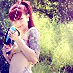 Third pic of Smoldering hot redhead Ivy Jean shows off her inked body in the garden all naked and sexy