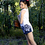 First pic of Exceptional slim brunette with delicate curves and small tits wearing white lingerie sensually undressing on a pink blanket in the woods. pics