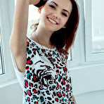 First pic of Nude Iva bares her petite body and delectable pussy on the chair.