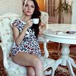 Second pic of Nude Iva bares her petite body and delectable pussy on the chair.