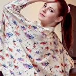 Second pic of Nude Juliett Lea strips on the chair baring her petite body and pink cherry.