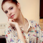 Third pic of Nude Juliett Lea strips on the chair baring her petite body and pink cherry.