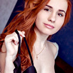 Fourth pic of Nude Redhead Nicole La Cray sensually strips her black lingerie on the bed.