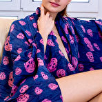 Second pic of Nude Cristin shows off her petite body and tight ass as she poses on the couch.