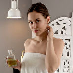 First pic of Nude Hazel slathers some massage oil on her body and starts stroking her smooth assets