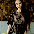 Fourth pic of Nude Leona Mia strips on the couch baring her petite body and sweet cherry.