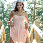 Third pic of Nude Newcomer Oxana Chic shows off her sexy, tanned body as she strips outdoors.
