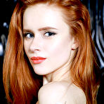 Second pic of Nude Redhead Bella Milano flaunts her petite, creamy body and pink cherry on the chair.