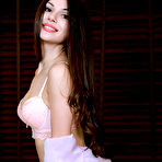 Third pic of Nude Newcomer Delphina flaunts her meaty pussy and tight ass on the bed.