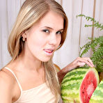 Second pic of Astonishing angel is sitting on the table with a sappy red watermelon, which excited her so much that she started self-service. gallery