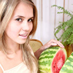 Third pic of Astonishing angel is sitting on the table with a sappy red watermelon, which excited her so much that she started self-service. gallery