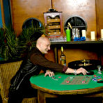 First pic of Clothed brunette Gina Killmer tortures nude man's cock and nipples on green table
