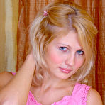 Third pic of Lovely blonde girl proudly displays a set of her sweet breasts while posing on the bed. free pictures