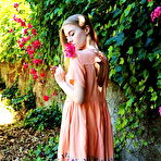 Third pic of Shayla flaunts her nubile body as she strips at the garden. naked