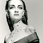 Third pic of Get an eyeful of the fair skin and soft curves that Kitty Fox brings to the table. She's hot as hell in booty shorts and a crop top t-shirt, but even better when she's down to just her thong. She's sweet, sexy, and eager to show off the dripping delight of her bald pussy. naked