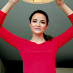 First pic of Blue-eyed brunette in red spreading her legs wide on a round table - aMetart.com