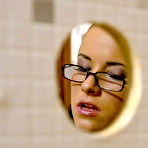 Second pic of Spectacled brunette Brandy Lee in black satin dress and sheer nylons has gloryhole sex
