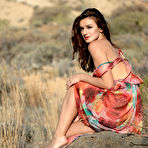 First pic of Elina Love undresses as the wind blows through her dress and long hair