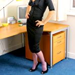 First pic of Sexy blonde secretary in black suit and purple nylons gets sexy in the office