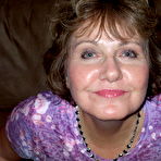 First pic of Busty Bliss - Hot busty cougar poses in her tie dyed skin tight top and flips the bird