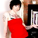 First pic of Topless brunette chick Hollywood demonstrates her tattoos and bare tits