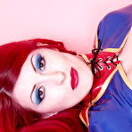 Fourth pic of Long haired fetish redhead Yolanda in tight blue latex dress reveals her boobs