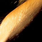 Fourth pic of Lori Anderson gives a smile and makes her playful eyes on you as she shows off her hairy arms