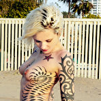 Second pic of Inked up blonde Voltaire strips nude and goes on the swings in her bare skin