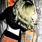 Second pic of Goth girl Keiko in red plaid skirt and black stockings displays her shaved spot