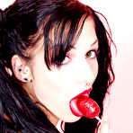 Second pic of Tattooed goth girl with lollipop Kellie Laplegua strips to show her pierced pussy and tits