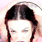 Third pic of Tattooed juicy titted goth brunette Zoe in pigtails strips down to her black thong panties