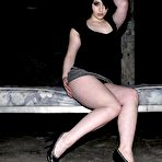 Fourth pic of Flirty black haired chick Syn in short skirt shows off her sexy legs and flashes her ass