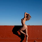 Fourth pic of Mia Valentine on rooftop in black lingerie and fishnet getting naked