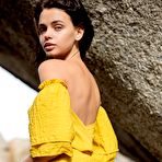 First pic of Brunette beauty Ariel revealing her small tits and ass on big rocks