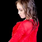 Fourth pic of Brunette in red Caesaria A is spreading legs showing off the trimmed cunt