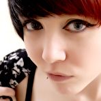 Third pic of Red-haired alt cutie Cassie strips down to her panties and shows her nice bare tits
