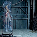 Third pic of SexPreviews - Stephie Staar in electro and metal bondage in dark dungeon her naked body exposed