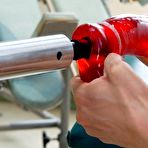 First pic of Pink nippled Lexi Bardot gives red robotic dildo a try on the exam table.