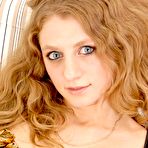 Second pic of Red haired teen Dory Nubiles strips her chic lingerie posing in nothing but black stockings.
