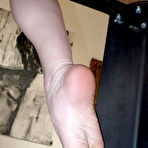 Second pic of Buxom brunette Rayveness with yellow rubber dildo in her pussy takes off her white high heels