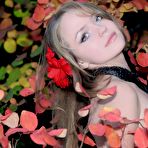 First pic of The beautiful blonde teen Manilla A is erotically posing naked against the blossoming bush