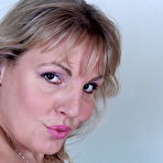 Fourth pic of Danielle Mannaken strips and plays with her giant boobs in red peek-a-boo lingerie