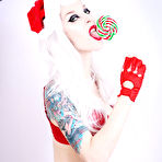 Third pic of White haired goth model Razor Candi in red Christmas lingerie shows off her tits