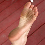 First pic of Tattooed brunette Kayla Jane removes her pink panties by the pool and exposes her feet